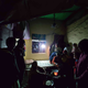A photo of the families of those arrested huddled together in a dimly lit room.